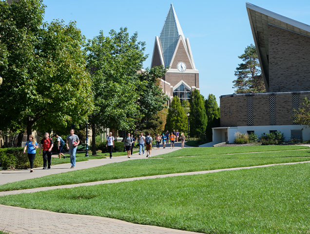 Xavier University campus with student walking