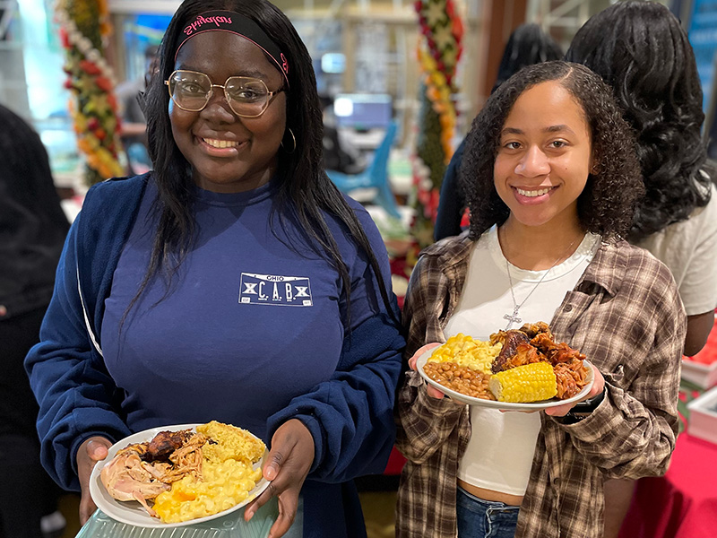 Two students with plates of food