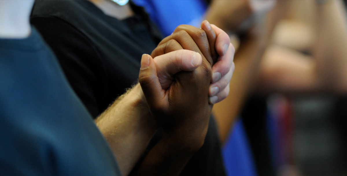 People holding hands in prayer