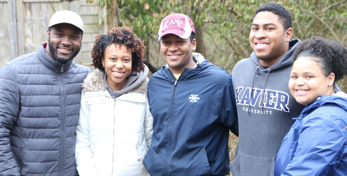 Five Xavier students smile at the camera