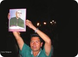 Photo of man holding up a picture