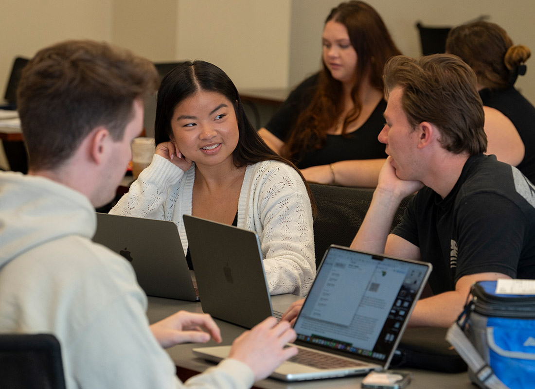 MBA students working on a group project at a table