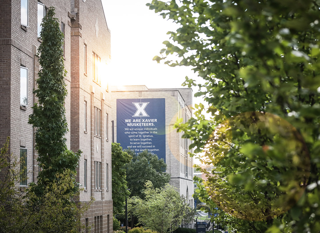 Photo of Xavier Campus with the Musketeer Saying