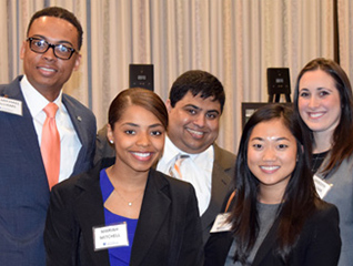 Group of five students in the customer analytics program smiling