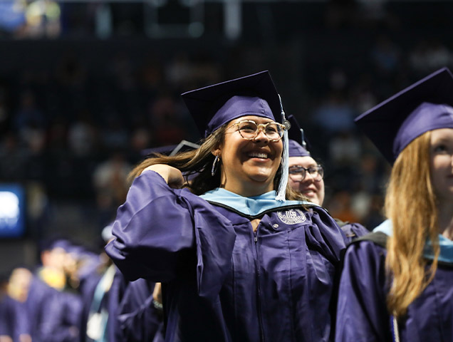 Xavier student graduating from college on a stage