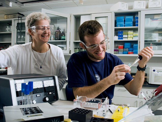 Xavier student and faculty in a medical lab working on a project together