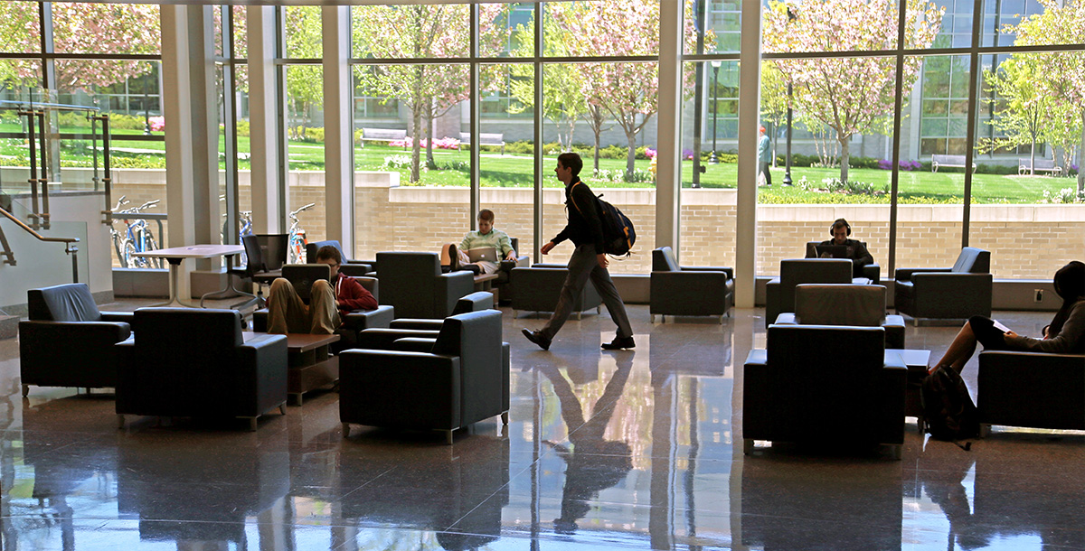 Student walking inside Smith Hall 