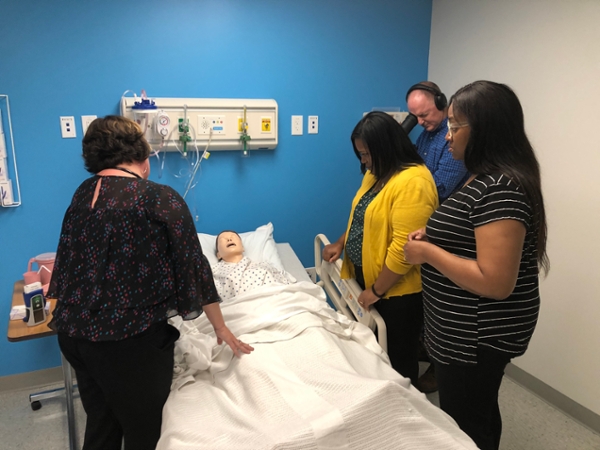 Professor and students testing the sim lab