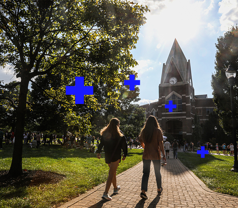 Two students walk into Gallagher Student Center on Xavier's campus in the evening.