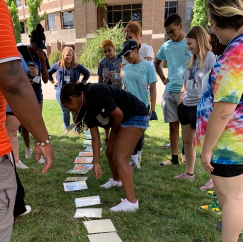 students working together on an activity on the ground