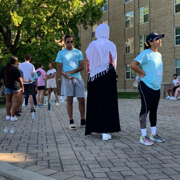 student standing outside talking to each other