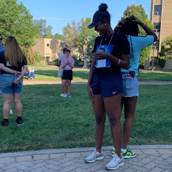 two students standing back to back during an activity