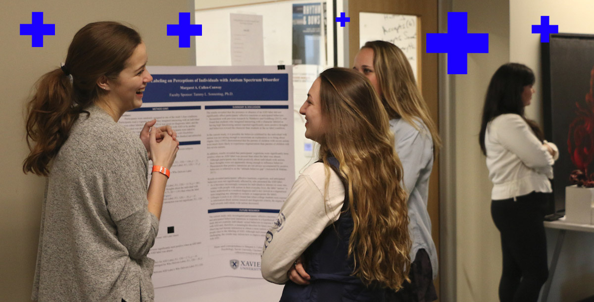 students standing around a poster with research
